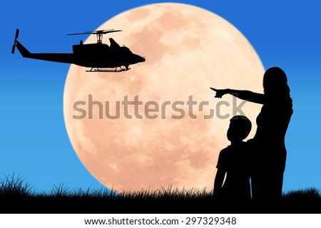 silhouette  mother hand point to helicopter at the full moon night background