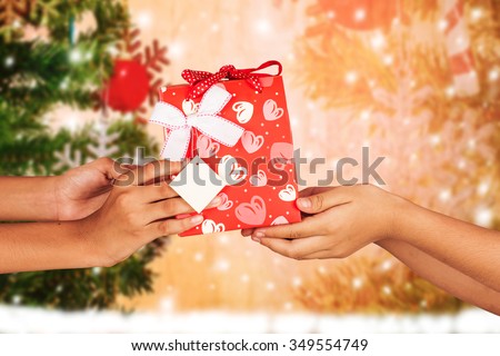 hand kid hold gift red gift box to friend christmas  background