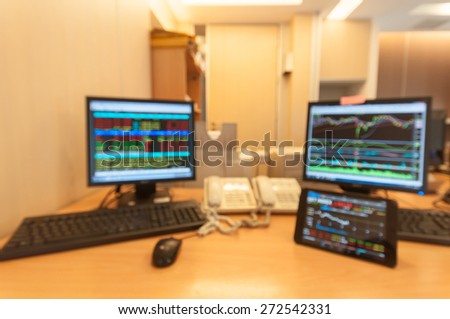 Monitor computer and monitor tablet stock market analysis for stock trading.Blur for background.