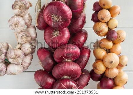 Two bunch of onion (sweet red onions and yellow onions) and bunch of garlic.