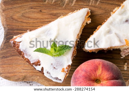 A piece of peach pie on a wooden board. Top view.