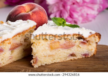 A piece of peach pie on a wooden board