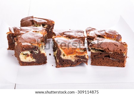 Chocolate cake with mascarpone. Marble cake cut into squares.