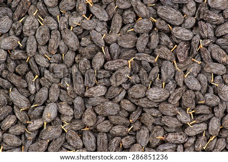 Black and yellow raisins on the wooden backgrounds.