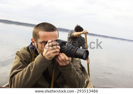 Men in boat on the river, shooting, adventure, real