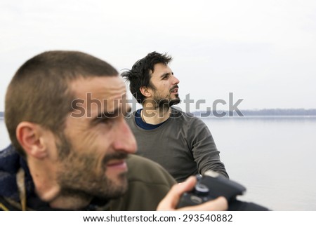 Men in boat on the river, shooting, adventure,dynamic, real