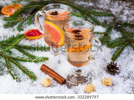mulled wine from white wine on a snow-covered background with fir-tree branches