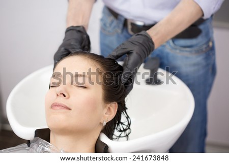 Woman washing hair in hair studio