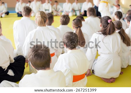 People in kimono sitting on tatami on martial arts training