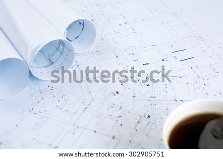 Construction plans and a cup of coffee