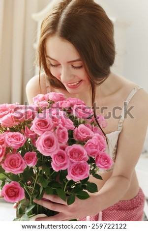 happy girl with big bouquet of pink roses, received as a gift