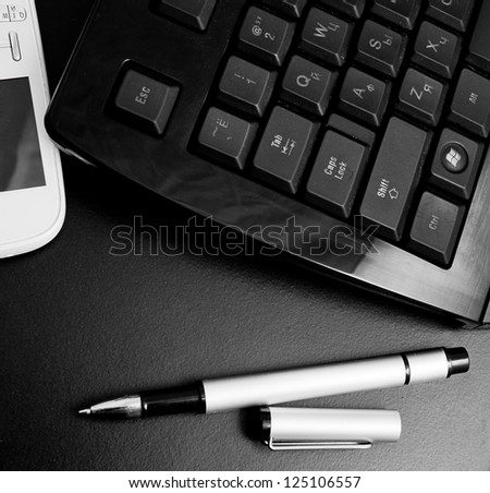 pen, computer keyboard and cell mobile phone