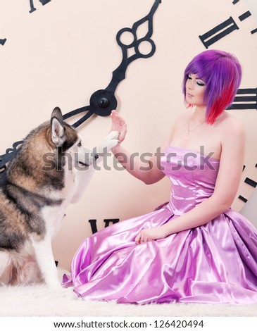 Give me paw. dog giving girl in pink dress a high five
