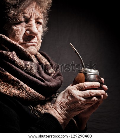 portrait of an old woman with Argentinean calabash in hands
