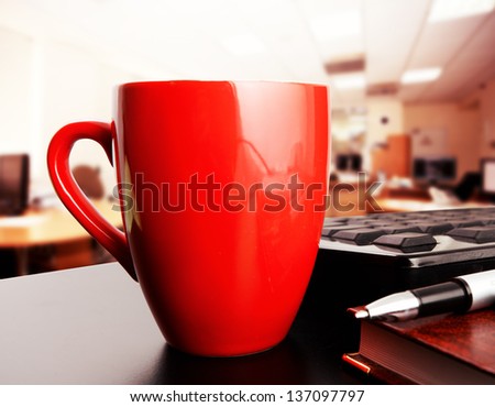 red cup of coffee in office