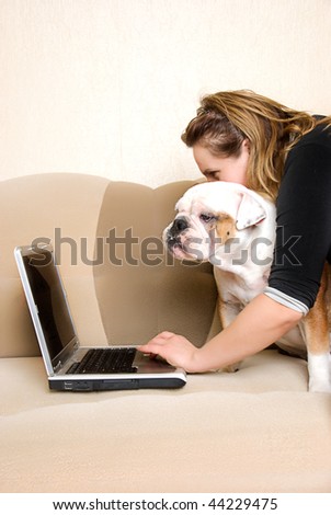 women and dog works with the laptop lying on the sofa