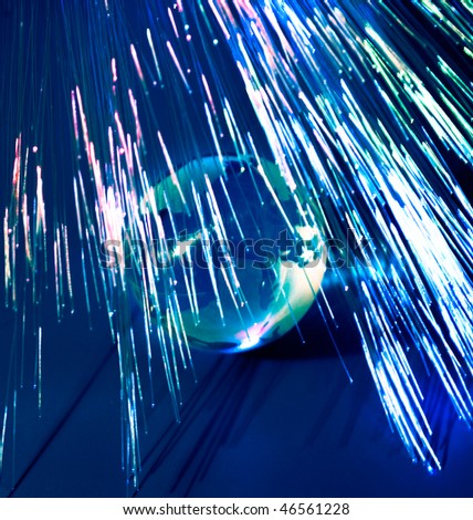 Optical fibers lights speeding  around the digital earth globe