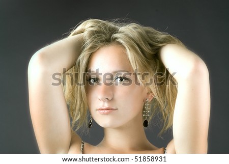 young beautiful woman with hands in hair