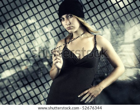 young woman in front of  metallic fence