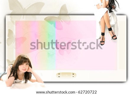 big screen and two girls, one sitting on it, one lying near it