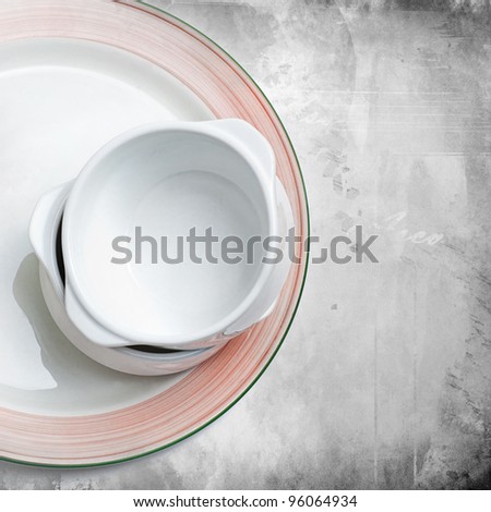 Stack of empty bowls on a plate on grunge background