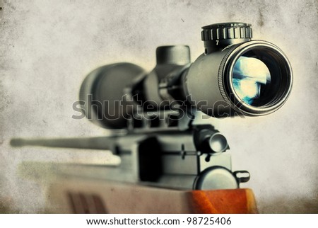 Closeup of a sniper rifle telescope glass lens on grunge background