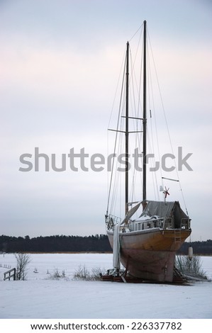 Sailing ship on shore in winter