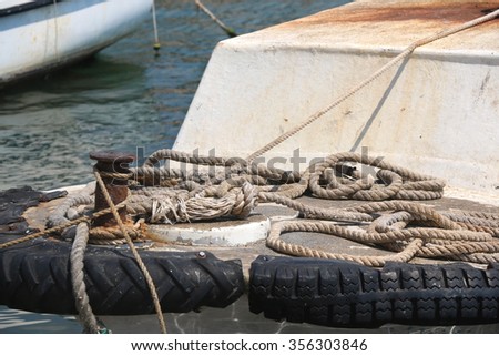 Nautical ropes on a rusty small boat, close-up.