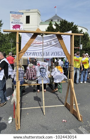 WARSAW, POLAND - MAY 11: Polish Prime Minister\'s picture hung on the symbolic gallows, during a protest action against the pension reform, outside parliament on May 11, 2012 in Warsaw, Poland.