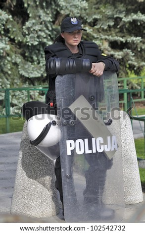 WARSAW, POLAND - MAY 11: Policewoman in riot gear, protecting a parliament building, during a protest of the Solidarity trade union against the pension reform on May 11, 2012 in Warsaw, Poland.