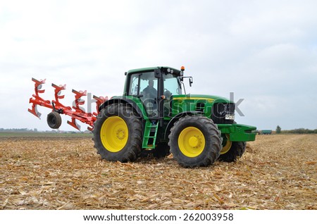 Skrzelew - October 09: Tractor-driver presenting a new model John Deere tractor (7530 series) with a reversible ploughs, during the XIII Days of Corn on October 09, 2011 in Skrzelew, Poland.