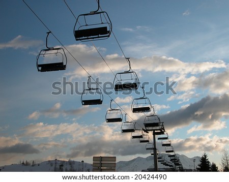 Ski lift chair, in the Alpine resort - against the background of the picturesque sky.