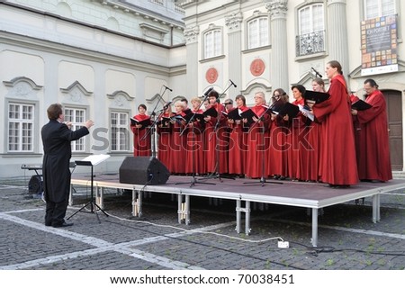 WARSAW - JUNE 28: The Choir of Singing Society from Saska Kepa sing during the concert in the court of the Warsaw Royal Castle on June 28, 2009 in Warsaw, Poland. Artur Backiel conducts the choir.