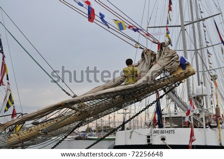 GDYNIA - JULY 4: Sailor on the bow of a sailing ship during the Tall Ships' Races Baltic 2009 held July 4, 2009 in Gdynia, Poland.