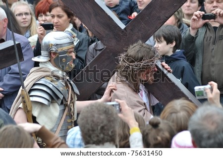 GORA KALWARIA - APRIL 17: Jesus carrying his cross, on the way to his crucifixion, during the street performances Mystery of the Passion on April 17, 2011 in Gora Kalwaria, Poland.