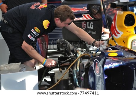 WARSAW - SEPTEMBER 04: Red Bull Racing mechanic, working on Mark Webber\'s car, after his demonstration ride, during the \