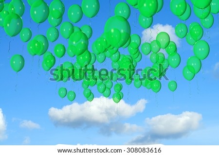 Green balloons flying in the sky