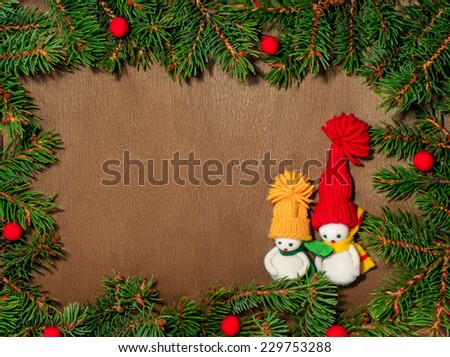 The snowmen, paper, envelope  and Christmas tree on a wooden wicker background