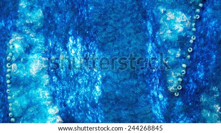 Turquoise  fabric texture of wool with lace and blue beads.  Craft background
