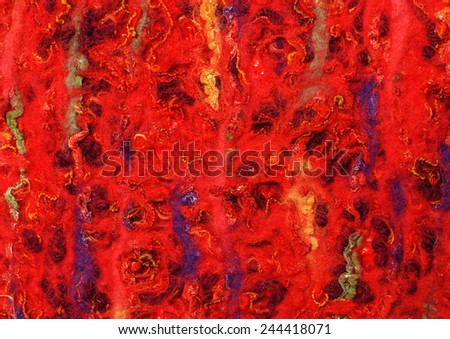 Red  fabric texture of wool with stick out shiny yarn. Craft background