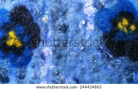 Blue fabric texture of wool with flowers.   Craft background