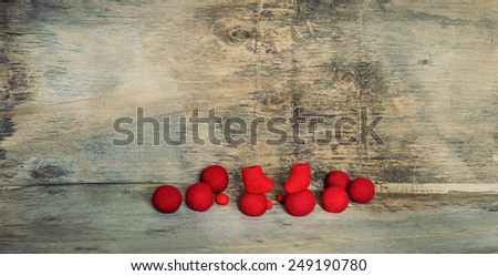 red felted beads and boots on the wooden background