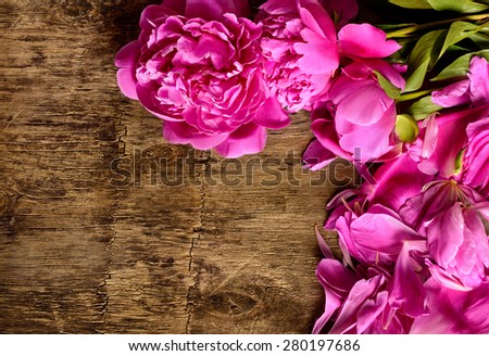 pink peonies on the wooden background