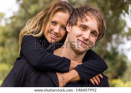 Happy young attractive couple portrait, smiling in outdoor environment