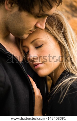 Romantic, tender moment of a young attractive couple. Pretty adorable girl closing her eyes