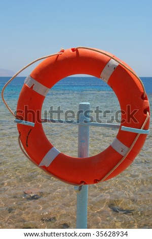 Red rescue circle on sea background.