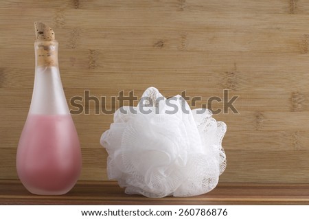 Bottle of Pink Bath Soap and White Sponge at the Spa