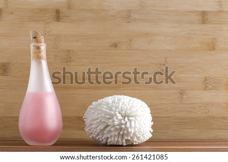 Pink Liquid Body Soap and White Sponge at the Spa