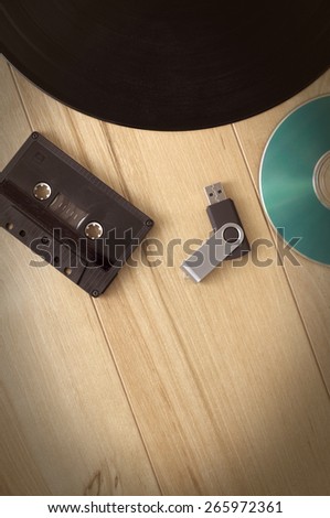 Vintage Looking image of Old Vinyl Record, Recording Cassette, Compact Disk and Usb Key