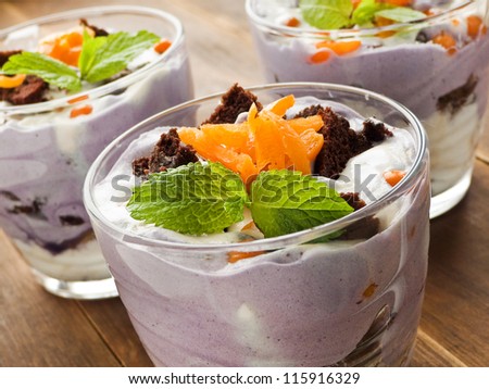 Dessert with ice-cream, whipped cream and berries. Shallow dof.